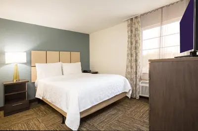 a bedroom with a large bed and a window at Candlewood Suites Fort Lauderdale Airport-Cruise by IHG in Fort Lauderdale