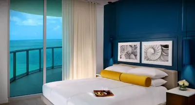 a bedroom with a bed with a view of the ocean at Sole Miami, A Noble House Resort in Miami Beach