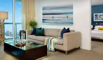a living room with a couch and a table at Sole Miami, A Noble House Resort in Miami Beach