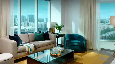 a living room with a couch and a chair at Sole Miami, A Noble House Resort in Miami Beach