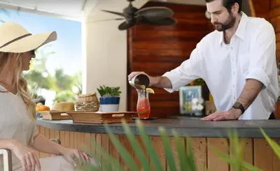 a man pouring a drink into a glass at Sole Miami, A Noble House Resort in Miami Beach
