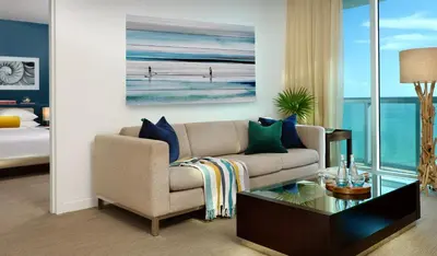 a living room with a couch and a table at Sole Miami, A Noble House Resort in Miami Beach