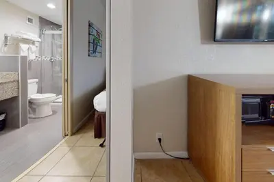 a bathroom with a sink and a toilet in a room at Rodeway Inn & Suites Fort Lauderdale Airport & Cruise Port in Fort Lauderdale