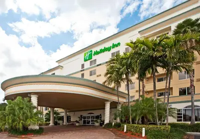 a hospital building with palm trees in front of it at Holiday Inn Fort Lauderdale Airport by IHG in Hollywood