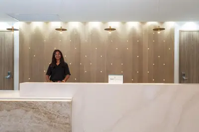 a woman is standing in front of a wall at Crowne Plaza Hotel & Resorts Fort Lauderdale Airport/ Cruise by IHG in Fort Lauderdale