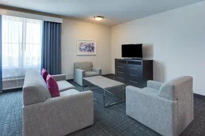 a hotel room with two couches and a television at Crowne Plaza Hotel & Resorts Fort Lauderdale Airport/ Cruise by IHG in Fort Lauderdale