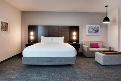 a hotel room with a bed and a chair at Crowne Plaza Hotel & Resorts Fort Lauderdale Airport/ Cruise by IHG in Fort Lauderdale