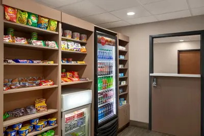 a room with a refrigerator and shelves of food at Holiday Inn Express & Suites Pembroke Pines-Sheridan St by IHG in Pembroke Pines