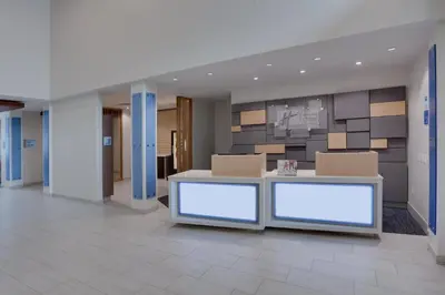 an office lobby with a reception desk and boxes at Holiday Inn Express Hotel & Suites Fort Lauderdale Airport/Cruise Port by IHG in Fort Lauderdale
