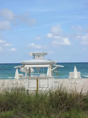 a lifeguard station on a beach with two chairs at Ocean Dream in Miami Beach