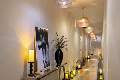 a hallway with lit candles and a hallway with lights at Dua Miami, Autograph Collection in Miami
