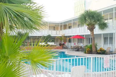 a view of a hotel with a pool and palm trees at Collins Hotel in Miami Beach