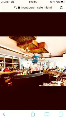 a restaurant with a bar with people sitting at tables at Apartment at De Soleil Hotel on Ocean Drive in Miami Beach