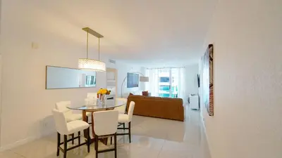 a dining room and living room with a table and chairs at Hollywood apartment by the sea in Hollywood