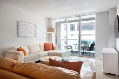 a living room with a couch and a table at Hollywood apartment by the sea in Hollywood