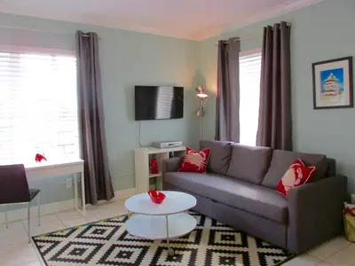a living room with a couch and a table at Ocean Breeze in Miami Beach