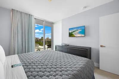 a bedroom with a bed and a large window at ABAE Hotel by Eskape Collection in Miami Beach