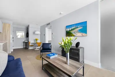 a living room with a vase of flowers on a table at ABAE Hotel by Eskape Collection in Miami Beach