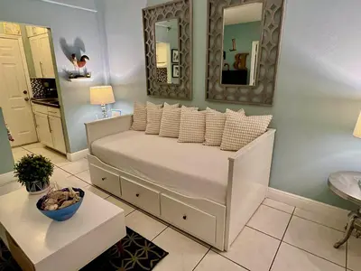 a bedroom with a bed with pillows and a mirror at Suite Love in Miami Beach