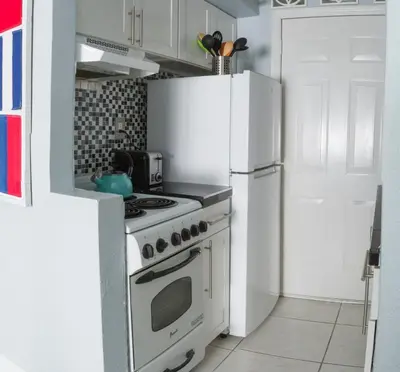 a kitchen with a white stove and a refrigerator at Suite Love in Miami Beach