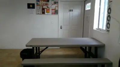 a bench in a room with a door and a window at Fatimataj Mahal in Miami