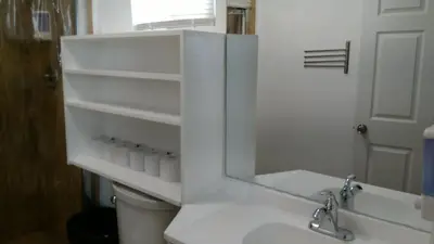 a bathroom with a sink and a toilet and a mirror at Fatimataj Mahal in Miami