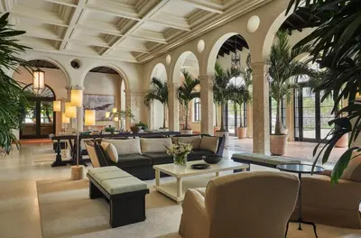 a lobby with a couch and a table and chairs at Four Seasons Hotel at The Surf Club in Miami Beach
