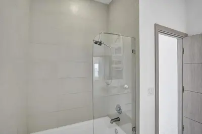a white bathroom with a shower and a tub at Modern Penthouse condo with 2 Large private terraces in Hollywood