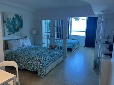 a bedroom with two beds and a blue ceiling at Ocean Front Studio Units in Miami Beach