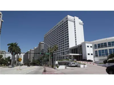 a large building in a city with a street at Ocean Front Studio Units in Miami Beach