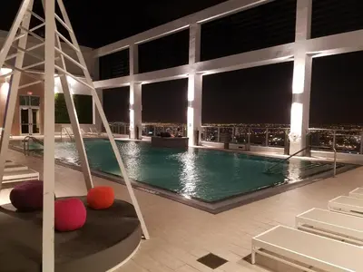 a swimming pool with a view of the city at night at Downtown Miami Deluxe Apartment in Miami
