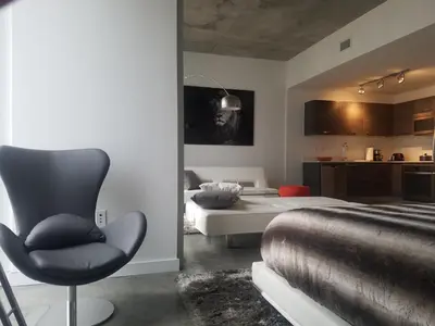 a bedroom with a bed and a chair in it at Downtown Miami Deluxe Apartment in Miami