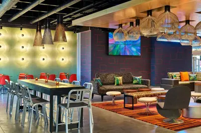 a dining room with a table and chairs at Aloft Miami Airport in Miami