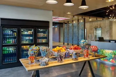 a table with bowls of fruit and drinks on it at Aloft Miami Airport in Miami