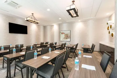 a conference room with tables and chairs with water bottles at Hampton Inn & Suites Miami Wynwood Design District, FL in Miami