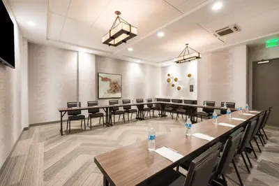 a conference room with a long table and chairs at Hampton Inn & Suites Miami Wynwood Design District, FL in Miami