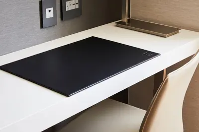 a desk with a black notebook on it at AC Hotel by Marriott Miami Aventura in Aventura