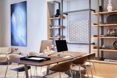 an office with a table with chairs and a laptop at AC Hotel by Marriott Miami Aventura in Aventura