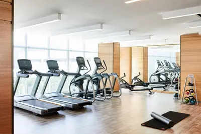 a gym with several treadmills and elliptical machines at AC Hotel by Marriott Miami Aventura in Aventura