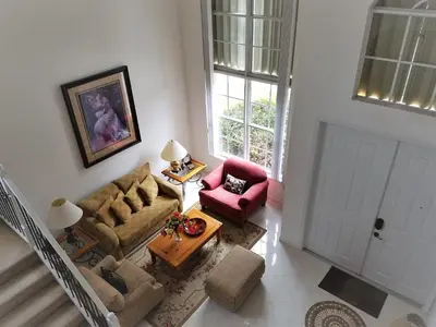 an overhead view of a living room with a couch and chairs at My Florida Lake House in Homestead