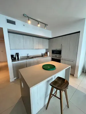 a kitchen with a island with a green plate on it at Luxury Beach Resort in Hollywood