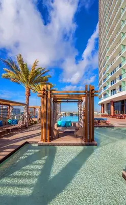 a pool with a pergola next to a building at Luxury Beach Resort in Hollywood