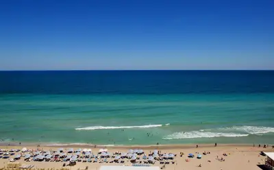 a group of people on a beach with the ocean at Luxury Beach Resort in Hollywood