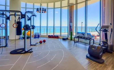 a gym with a view of the ocean at Luxury Beach Resort in Hollywood