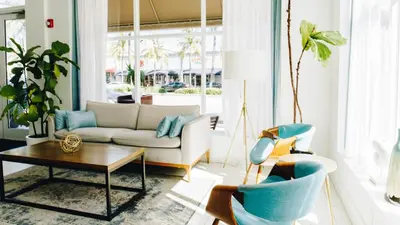 a living room with a couch and a table and chairs at Casa Boutique Hotel in Miami Beach
