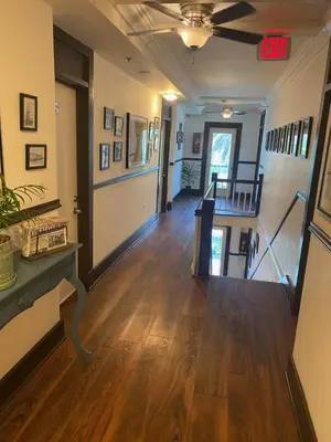 an empty hallway with wood floors and a stairway at Hotel Ponce de Leon in Miami