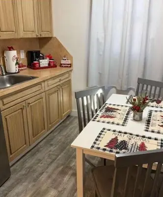 a kitchen with a table and chairs and a sink at Hotel Ponce de Leon in Miami