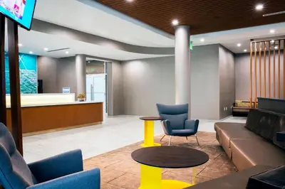 a lobby with a couch and chairs and a table at SpringHill Suites by Marriott Miami Doral in Miami