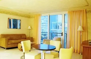 a living room with a couch and a table and chairs at The Fritz Hotel in Miami Beach
