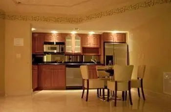 a kitchen with a table and chairs and a refrigerator at The Fritz Hotel in Miami Beach